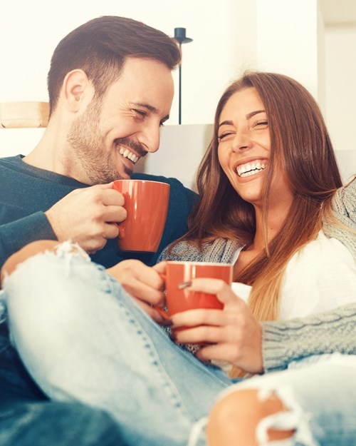 couple laughing with coffee